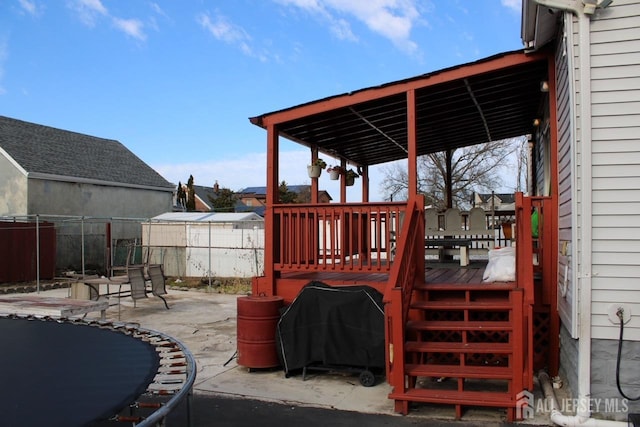 exterior space featuring area for grilling, a patio, and a trampoline