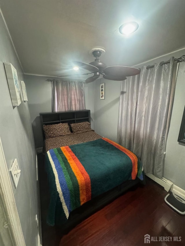 bedroom featuring ceiling fan and dark wood-type flooring