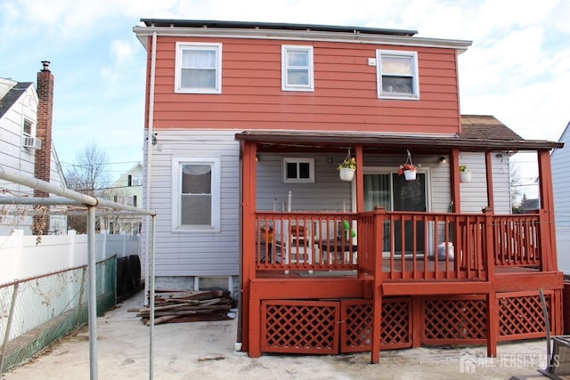 rear view of house featuring a deck