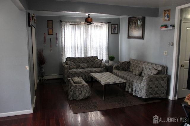 living room with dark hardwood / wood-style floors, ceiling fan, and a baseboard heating unit