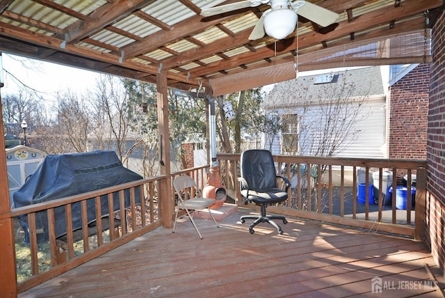 wooden terrace with a ceiling fan