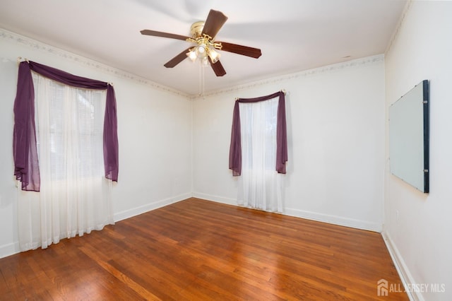 unfurnished room featuring wood-type flooring, baseboards, and a ceiling fan