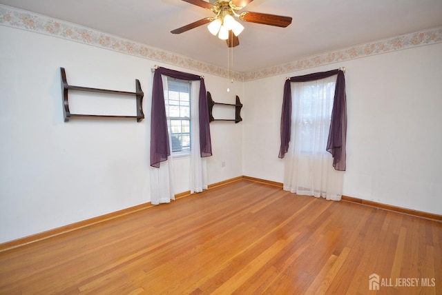 unfurnished room featuring baseboards, ceiling fan, and light wood finished floors