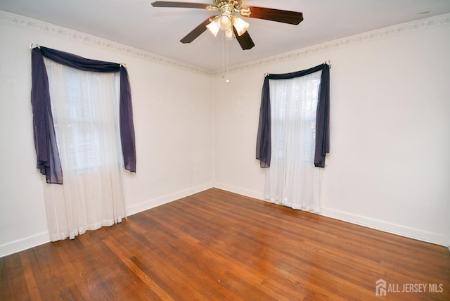 spare room with wood-type flooring, baseboards, and a ceiling fan