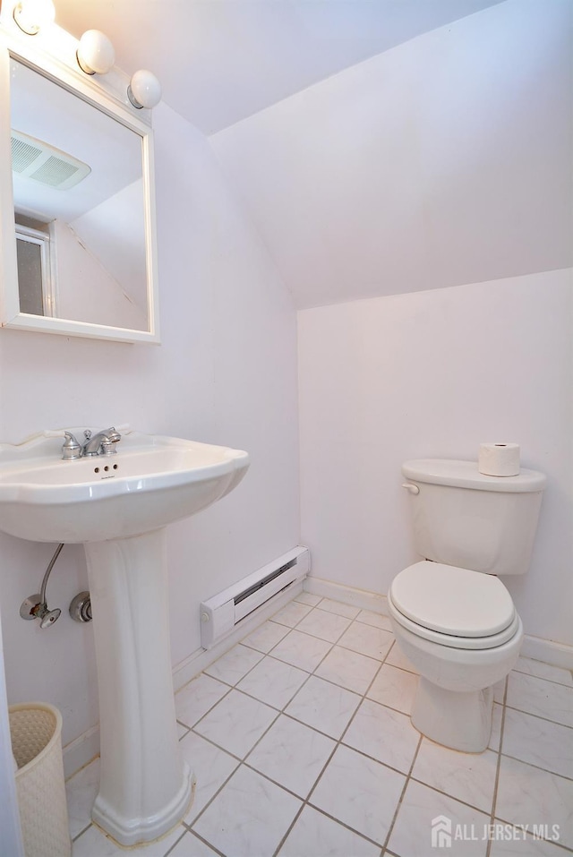 half bath with visible vents, toilet, tile patterned flooring, vaulted ceiling, and a baseboard heating unit