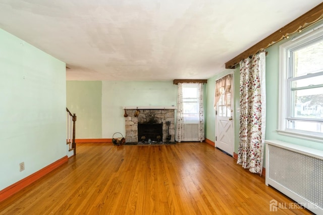 571 Greenbrook Rd, North Plainfield, NJ 07063 - unfurnished living room featuring radiator, light wood-style floors, and a fireplace