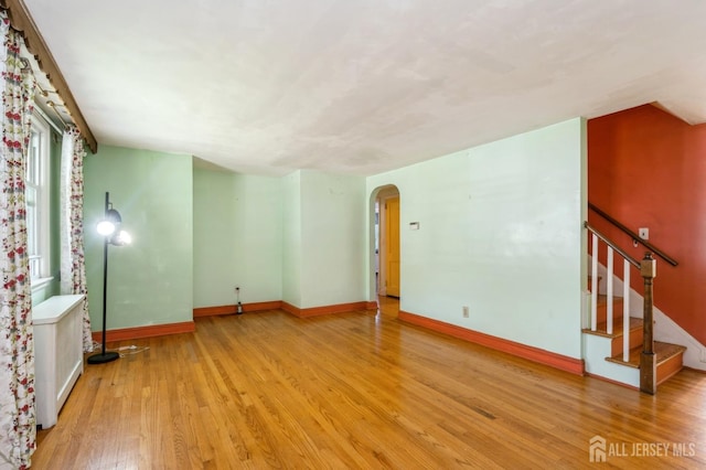 571 Greenbrook Rd, North Plainfield, NJ 07063 - unfurnished living room with arched walkways, wood finished floors, and stairs