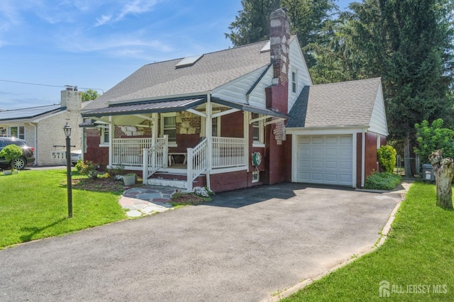 571 Greenbrook Rd, North Plainfield, NJ 07063 - view of front of house featuring a porch, asphalt driveway, a shingled roof, a front yard, and an attached garage