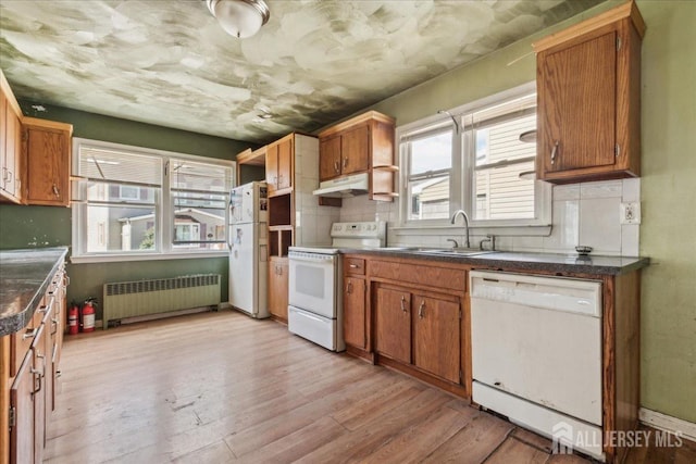 399 Highland St, South Amboy, NJ 08879 - kitchen featuring radiator, white appliances, a sink, light wood-style floors, and dark countertops