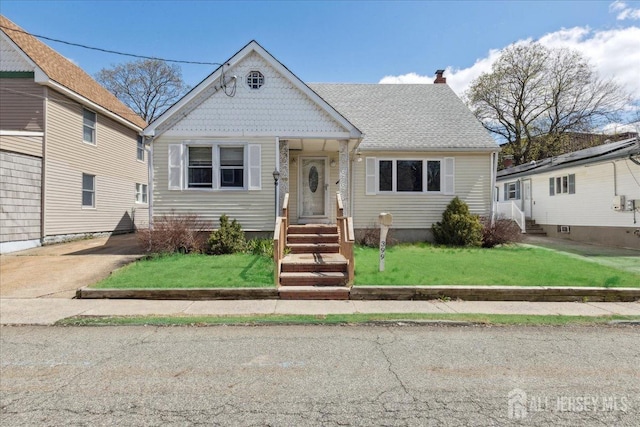 399 Highland St, South Amboy, NJ 08879 - victorian-style house featuring a front yard and a chimney