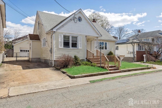399 Highland St, South Amboy, NJ 08879 - victorian home with concrete driveway, a garage, a gate, a chimney, and roof with shingles