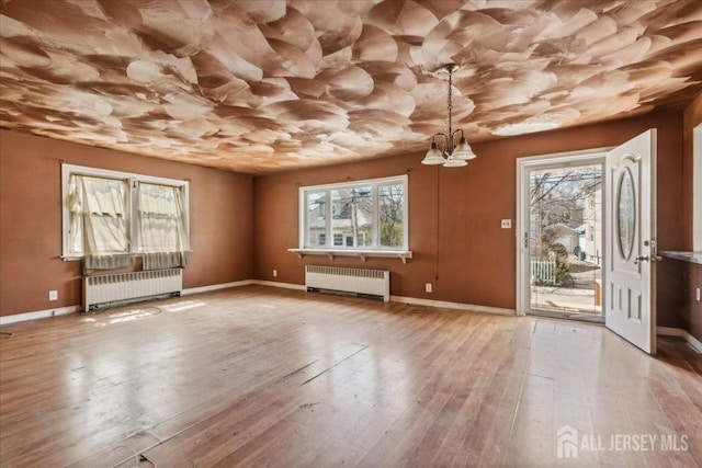 399 Highland St, South Amboy, NJ 08879 - unfurnished living room with radiator heating unit, plenty of natural light, and baseboards