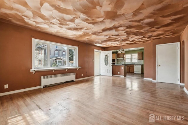 399 Highland St, South Amboy, NJ 08879 - unfurnished living room with radiator, baseboards, and wood finished floors