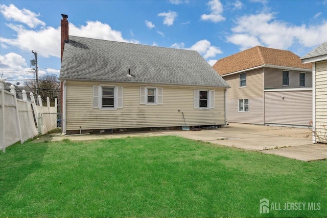 399 Highland St, South Amboy, NJ 08879 - rear view of house with a patio area, a chimney, and roof with shingles