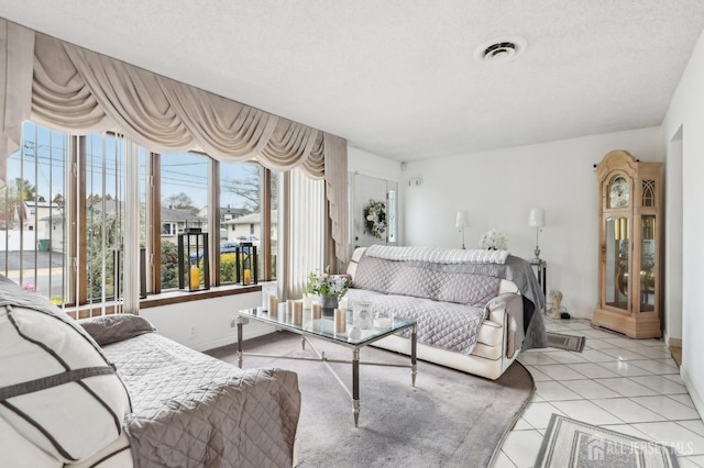 living room featuring light tile patterned flooring and a textured ceiling