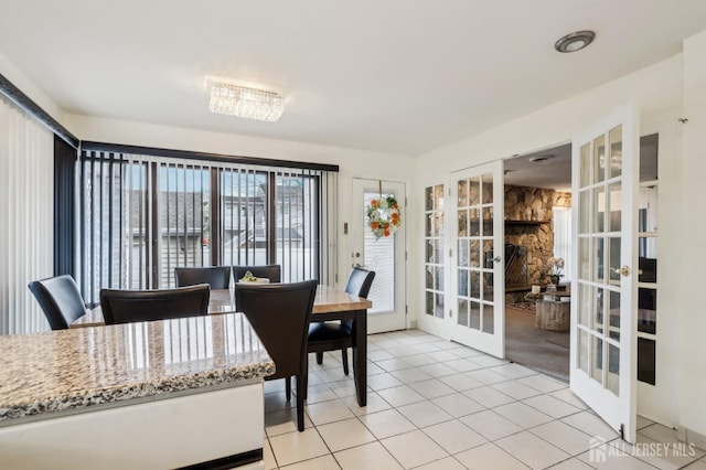 dining area with french doors and light tile patterned flooring
