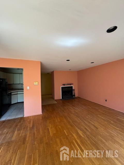 165 Penn Ct, Old Bridge, NJ 07747 - unfurnished living room featuring wood finished floors