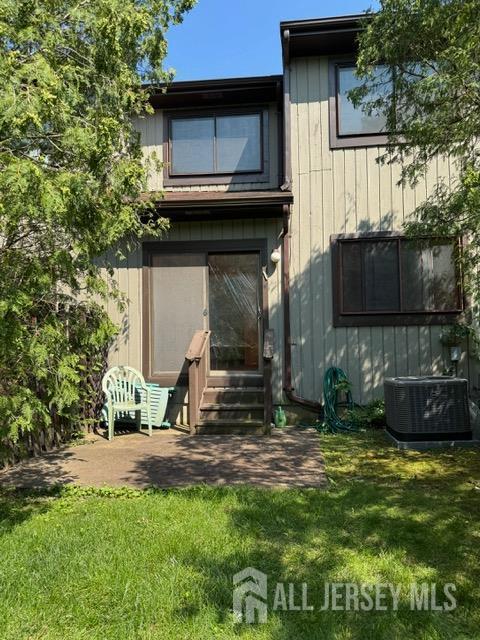 165 Penn Ct, Old Bridge, NJ 07747 - back of house with entry steps, cooling unit, and a lawn