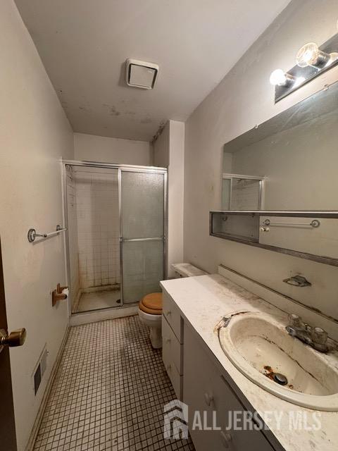 165 Penn Ct, Old Bridge, NJ 07747 - full bath featuring toilet, vanity, a stall shower, and tile patterned floors