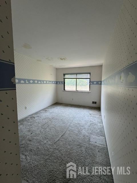 165 Penn Ct, Old Bridge, NJ 07747 - carpeted empty room with wallpapered walls