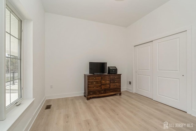 bedroom featuring a closet and light wood-type flooring