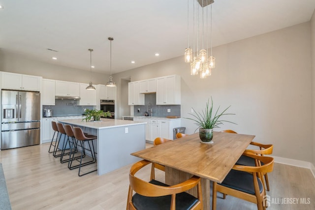 dining space with light hardwood / wood-style flooring