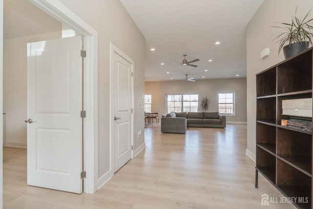 hallway with light hardwood / wood-style flooring