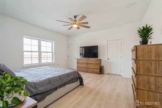 bedroom with ceiling fan and light wood-type flooring