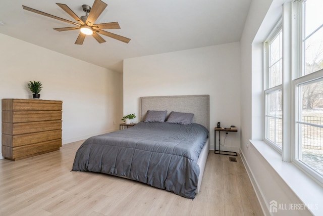 bedroom with ceiling fan and light hardwood / wood-style flooring