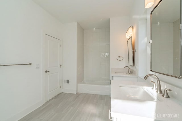 bathroom featuring vanity and tub / shower combination