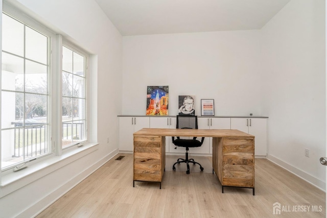 home office featuring light hardwood / wood-style flooring and plenty of natural light