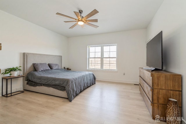 bedroom with ceiling fan and light hardwood / wood-style floors