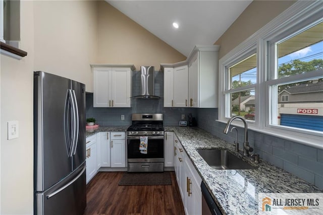 119 Brown Ave, Iselin, NJ 08830 - kitchen with stainless steel appliances, wall chimney exhaust hood, white cabinetry, light stone countertops, and vaulted ceiling