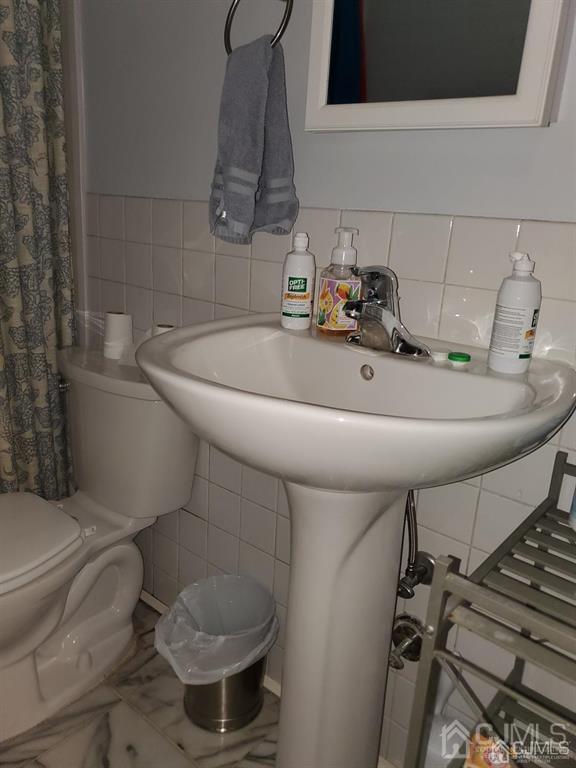 18 Judson St Unit 3A, Edison, NJ 08837 - bathroom with tile walls, curtained shower, and marble finish floors