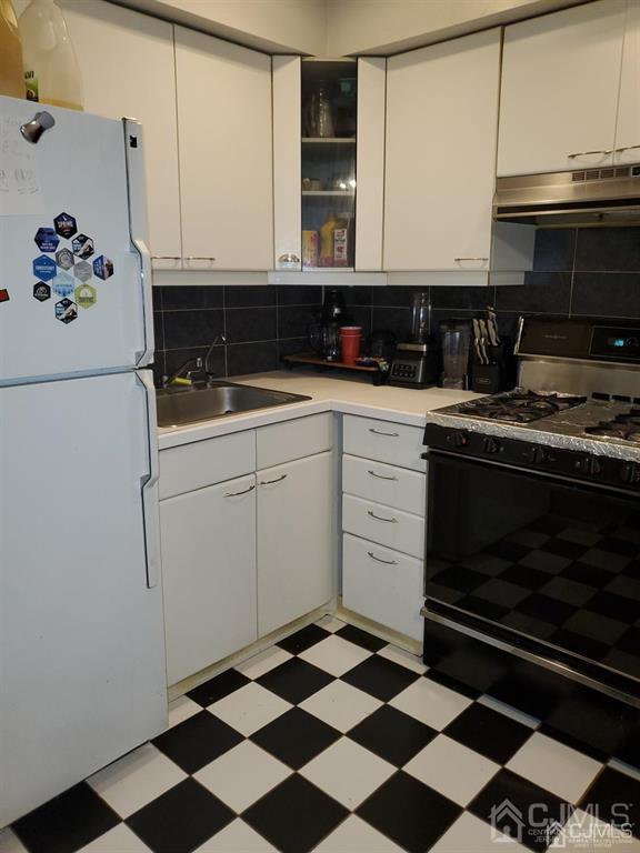 18 Judson St Unit 3A, Edison, NJ 08837 - kitchen featuring freestanding refrigerator, black range with gas stovetop, under cabinet range hood, light floors, and white cabinets
