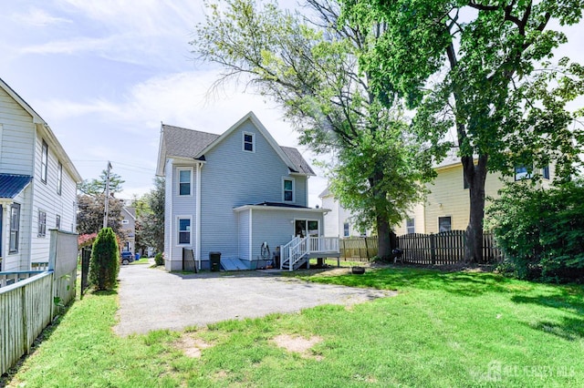 back of house with a deck