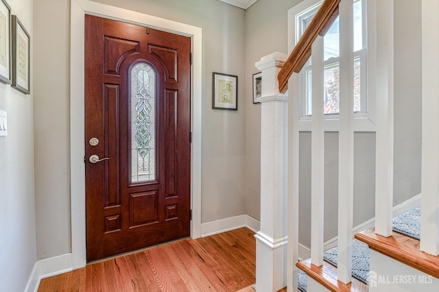 foyer entrance featuring light wood-style flooring and baseboards