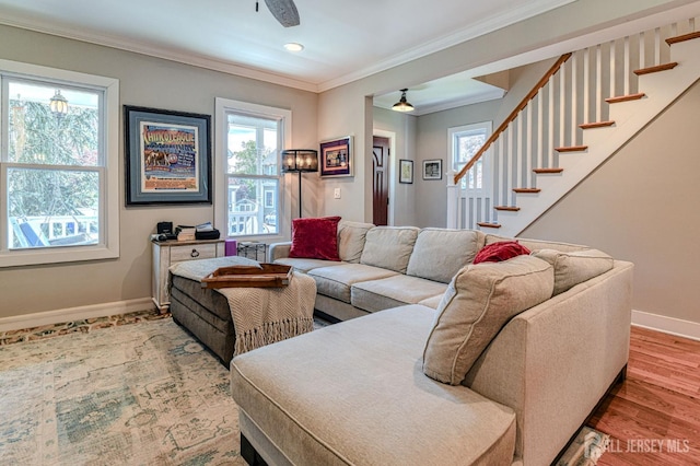 living room featuring baseboards, plenty of natural light, stairway, ornamental molding, and recessed lighting
