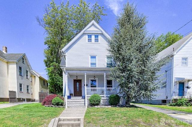 view of front of home with covered porch and a front yard