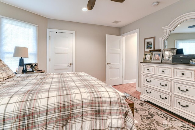 bedroom featuring light wood-type flooring, ceiling fan, and baseboards