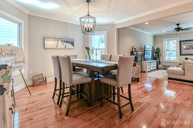 dining area with light wood-style flooring, a chandelier, plenty of natural light, recessed lighting, and ornamental molding