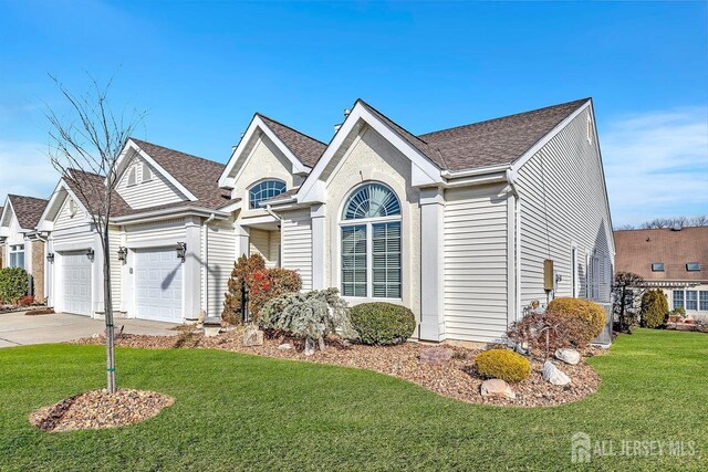 ranch-style home with a garage and a front lawn