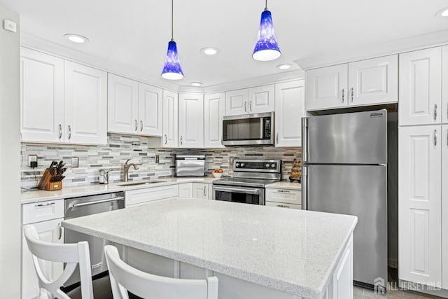 675 Bound Brook Rd Unit C0019, Dunellen, NJ 08812 - kitchen featuring stainless steel appliances, white cabinets, hanging light fixtures, tasteful backsplash, and recessed lighting