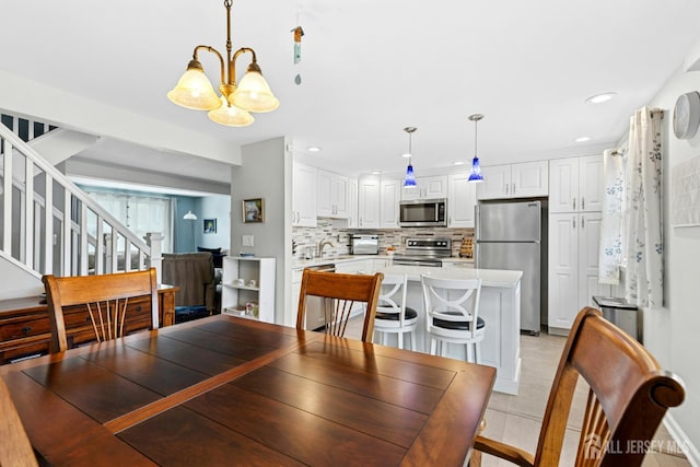 675 Bound Brook Rd Unit C0019, Dunellen, NJ 08812 - dining area featuring a chandelier, stairway, and recessed lighting