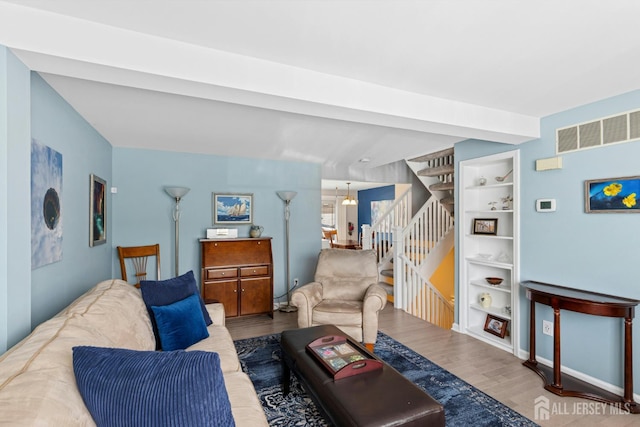 675 Bound Brook Rd Unit C0019, Dunellen, NJ 08812 - living room featuring wood finished floors, stairs, and built in shelves