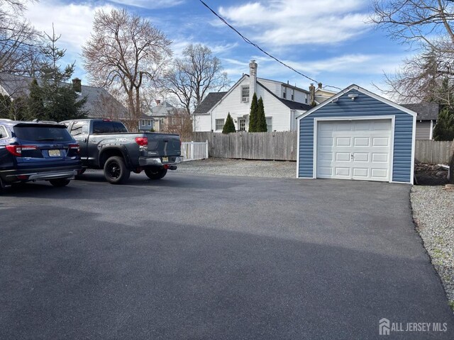 220 S Washington Ave, Dunellen, NJ 08812 - view of property exterior with driveway, an outdoor structure, and a detached garage