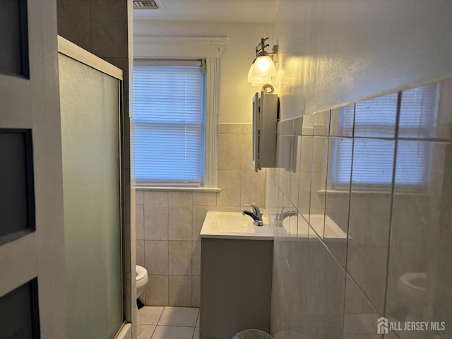 220 S Washington Ave, Dunellen, NJ 08812 - bathroom with tile walls, vanity, a shower stall, tile patterned flooring, and healthy amount of natural light