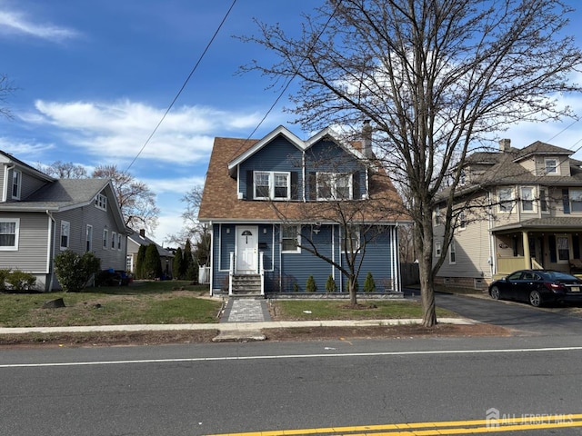 220 S Washington Ave, Dunellen, NJ 08812 - view of front of house with a chimney and a front lawn