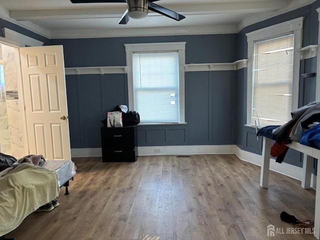 220 S Washington Ave, Dunellen, NJ 08812 - bedroom with hardwood / wood-style flooring, beamed ceiling, a decorative wall, and ceiling fan
