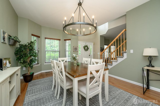 274 Pinelli Dr, Piscataway, NJ 08854 - dining room featuring a chandelier, wood finished floors, and stairway